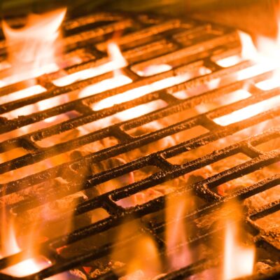 Closeup of charcoal burning under a barbecue grill